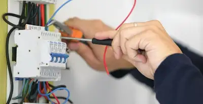 Electrician installing and adjusting circuit breakers in an electrical panel in Easton, PA
