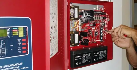 fire alarm installation service showing technician configuring fire alarm control panel in Easton, PA