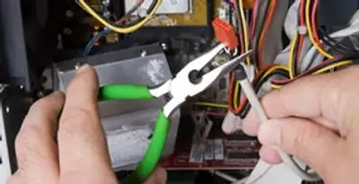 Licensed electrical contractor performing electrical repair with tools in Riegelsville, PA