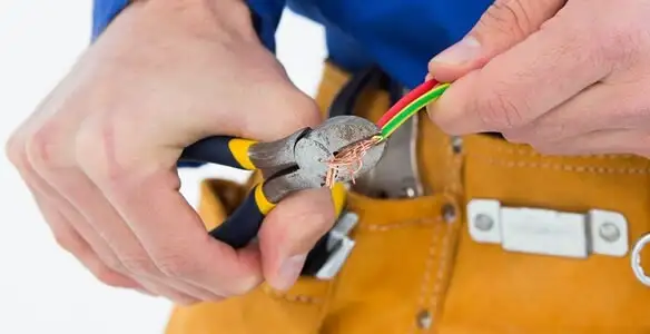 licensed electrician securing electrical wiring with professional tools during service work in Easton, PA