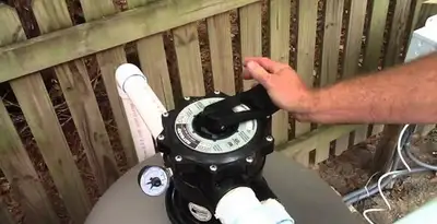 pool pumps service showing professional adjustment of pool pump control system in Easton, PA