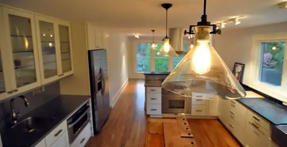 Residential electrician installing modern indoor light fixture in a home in Easton, PA