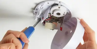 Certified technician wiring smoke detector during installation in Easton, PA